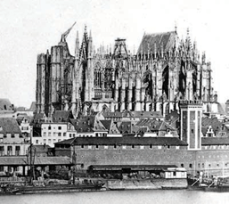 A black and white photo of the outside of Cologne Cathedral.