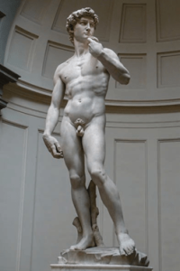 A full-length, nude marble sculpture of David who is holding a stone in one hand and has his sling over his shoulder.