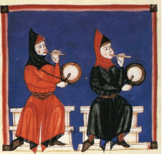 Two people sitting side by side who are both blowing into a fife they are holding with one hand and beating a drum with the other hand.