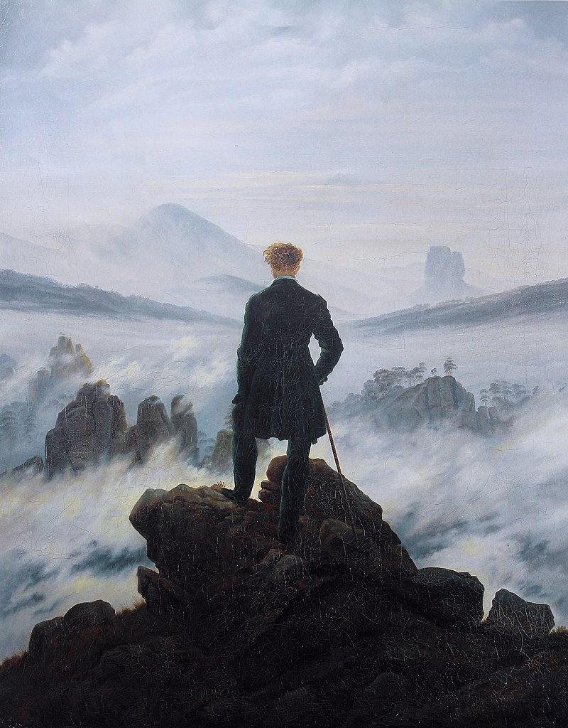 A solitary figure stands atop a rocky precipice, gazing over a vast expanse of fog-covered landscape, evoking contemplation.