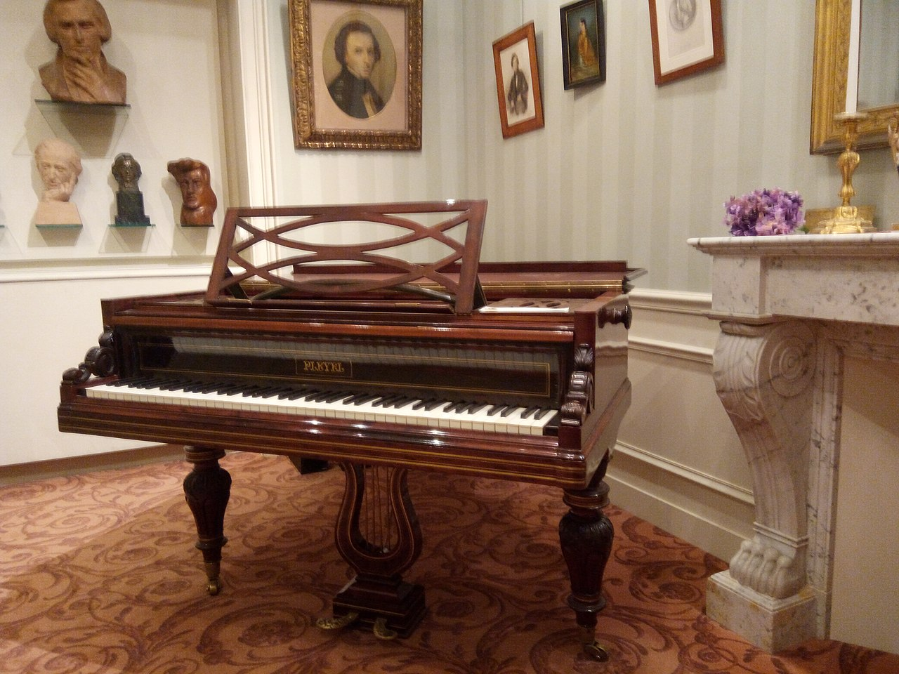 A grand piano positioned elegantly in a well-lit room, showcasing its polished surface and inviting ambiance.