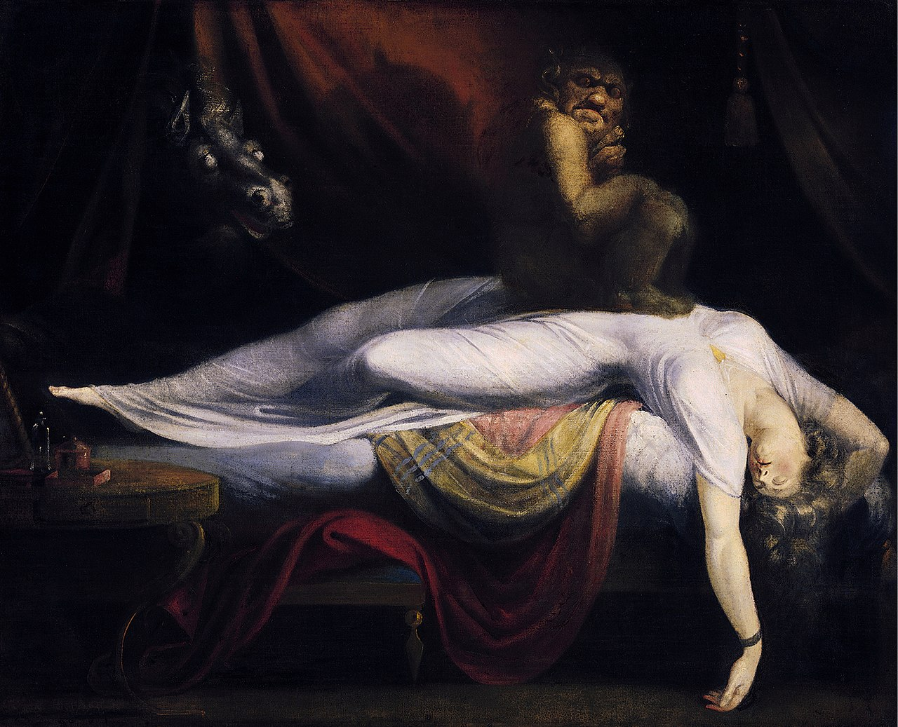 A woman reclines on a bed, a gargoyle perched on her stomach