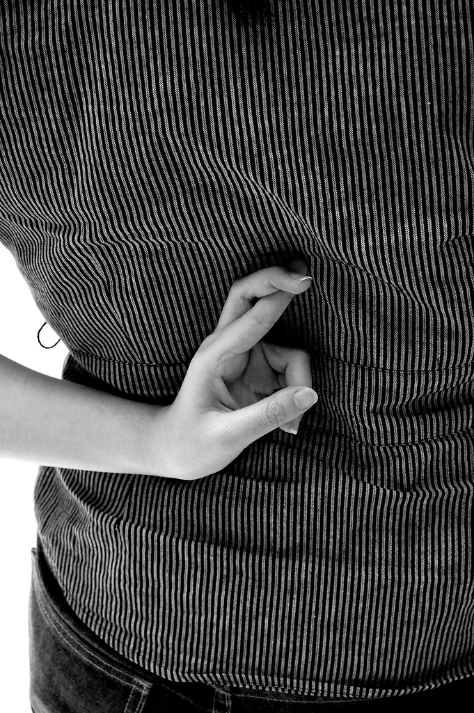 A woman crossing her fingers behind her back