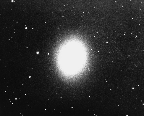 Dwarf Elliptical Galaxy M32. This companion to the Andromeda Galaxy is, like most ellipticals, a featureless and uniform oval of light. Note that individual stars can be seen at the edges where the density of stars declines.